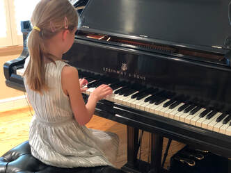 Picture of a young girl playing the piano